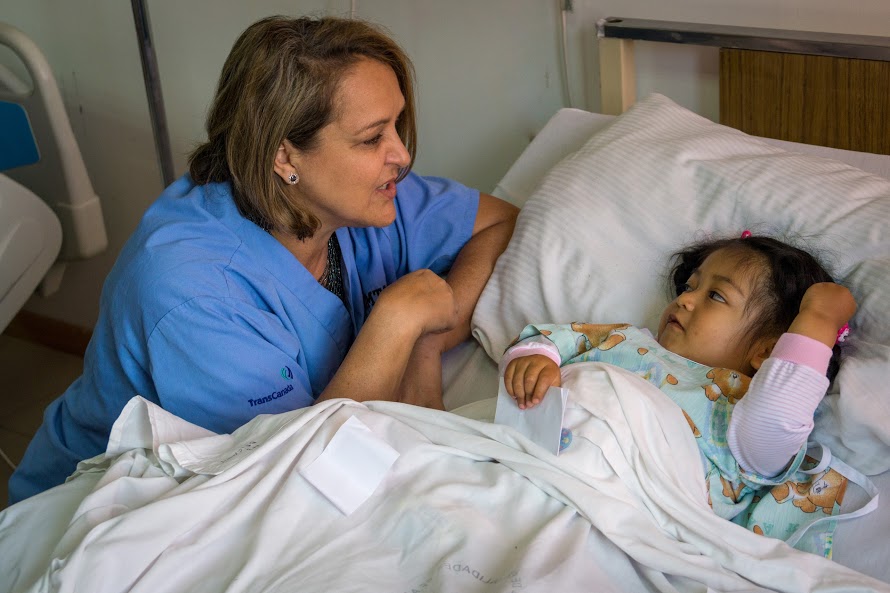A CAMTA nurse talking to a child patient in bed