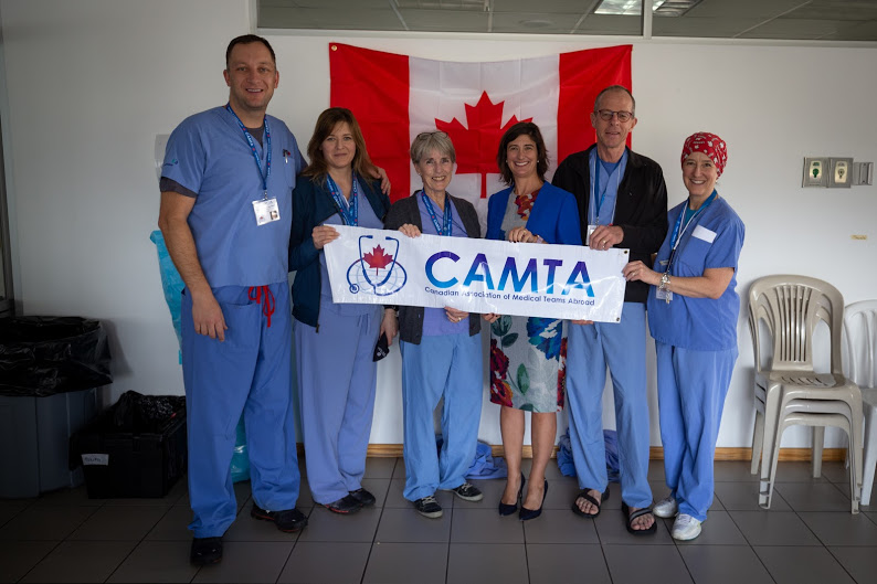 CAMTA team standing behind a camta banner